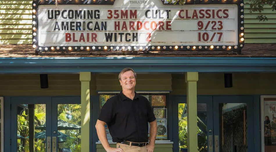 Executive Director Wade Neal stands beneath the 35mm marquee at Enzian Theater in Maitland, Florida.