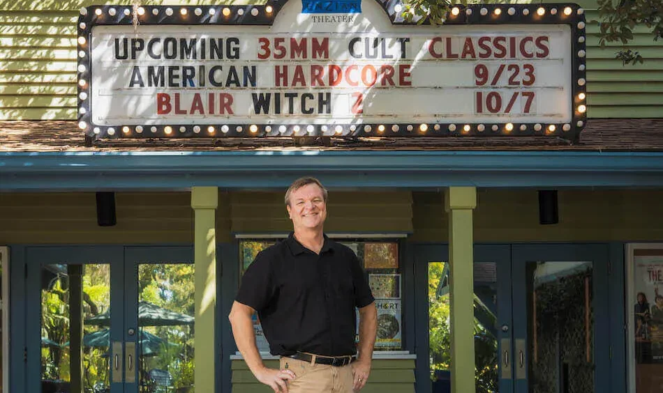 Executive Director Wade Neal stands beneath the 35mm marquee at Enzian Theater in Maitland, Florida.