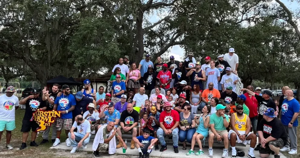 Multicultural crowd at Love & Loyalty Weekend BBQ event in Orlando park setting