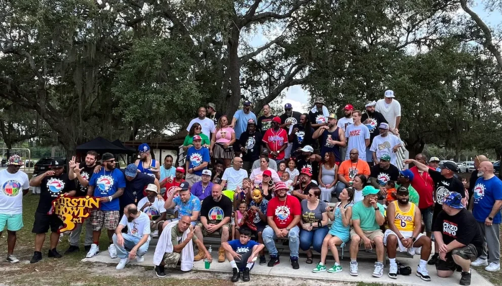 Multicultural crowd at Love & Loyalty Weekend BBQ event in Orlando park setting