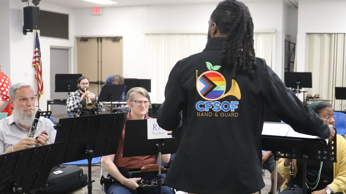 Associate Director Marques Rudd talks to musicians during a rehearsal of Central Florida Sounds of Freedom Band