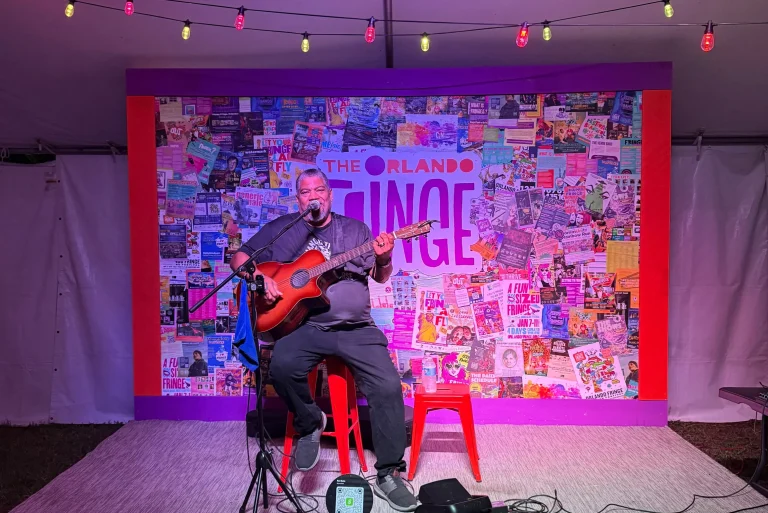 Big Ron Betts plays guitar on the Late Night Stage at Orlando International Fringe Theater Festival