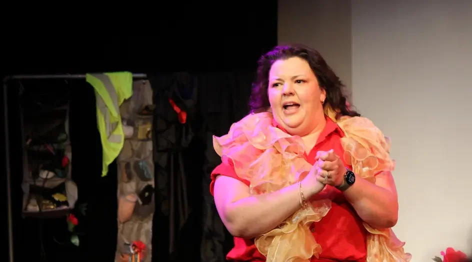 Diane Jorge interacts stands on stage during Solovela at Orlando Fringe Festival.
