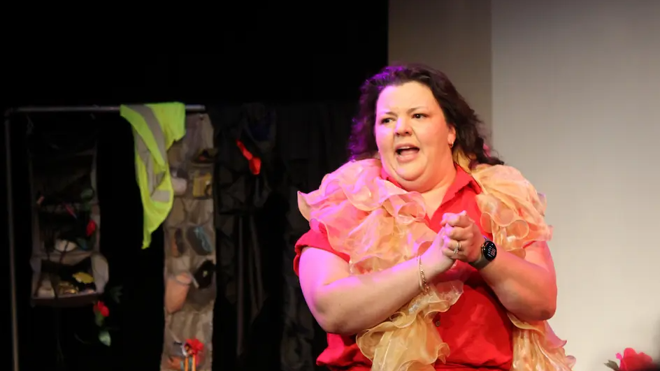 Diane Jorge interacts stands on stage during Solovela at Orlando Fringe Festival.
