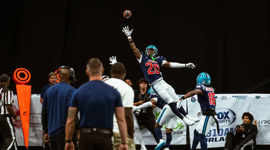 Leon O'Neal Jr. making a one handed attempt at catching a fotoball pass in mid-air.