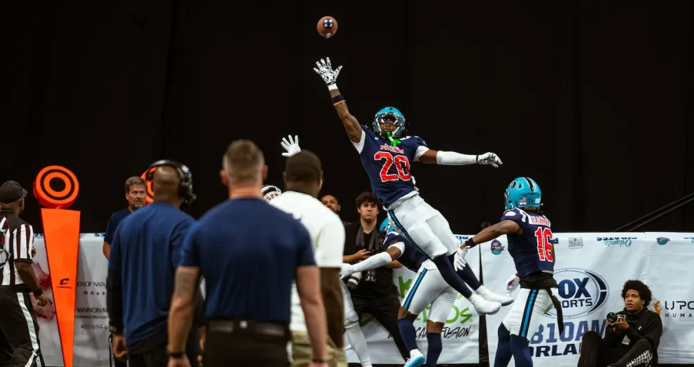 Leon O'Neal Jr. making a one handed attempt at catching a fotoball pass in mid-air.