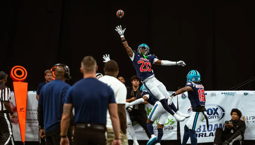 Leon O'Neal Jr. making a one handed attempt at catching a fotoball pass in mid-air.