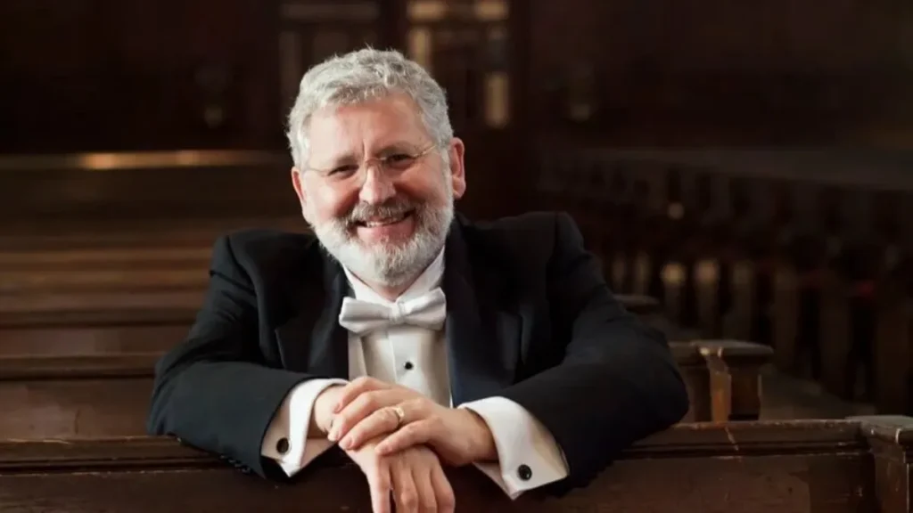 DR. John V. Sinclair sitting in a pew.
