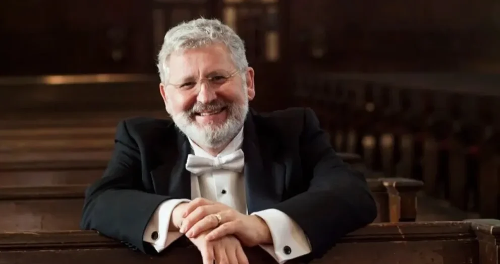 DR. John V. Sinclair sitting in a pew.