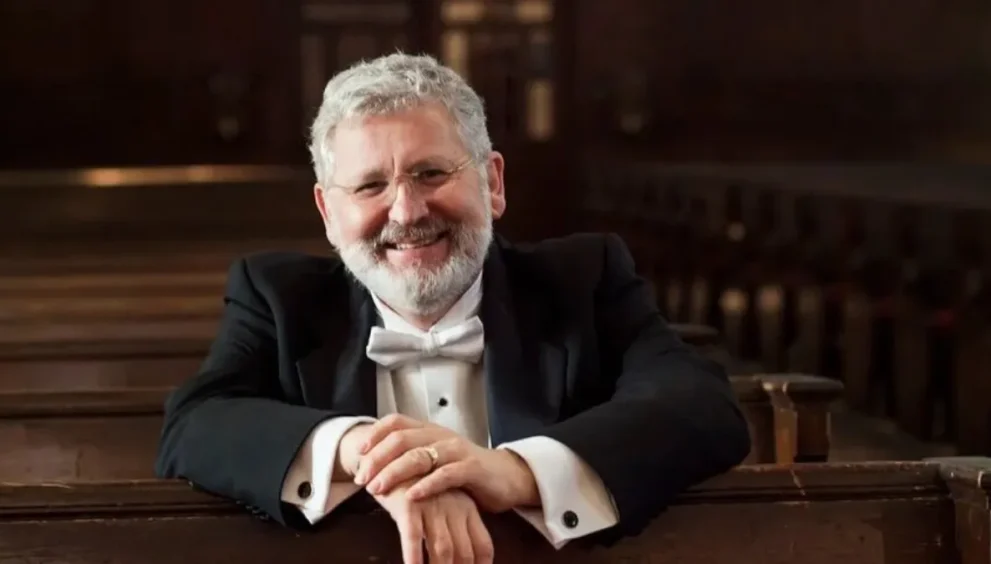 DR. John V. Sinclair sitting in a pew.